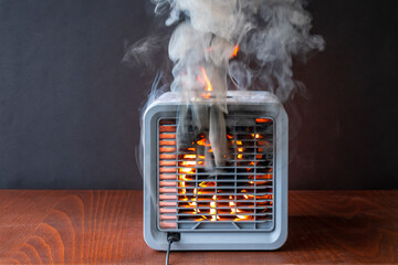 Air purifier burns with fire, flames and sparks, black smoke.  The cause of the fire in the...