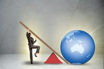 Businessman lifting the earth globe in challenge concept - obrazy, fototapety, plakaty