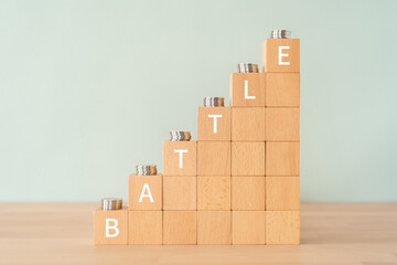 「BATTLE」と書かれた積み木とコイン