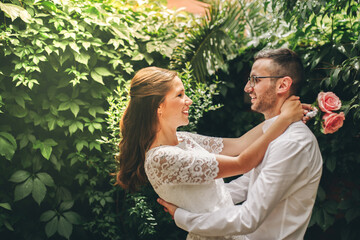 Newlywed couple looking at each other hugging dance and smiling on their wedding day. Union and...