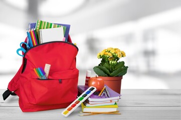Bright backpack on table home. School supplies. Back to school concept. Educational design objects.