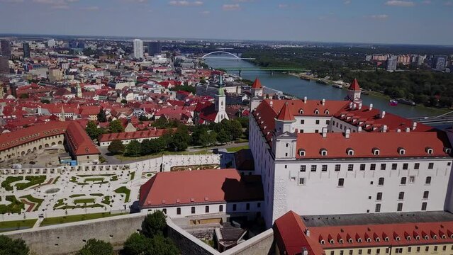 Cinematic 4K aerial drone trucking shot of the Bratislava Castle with its elaborate garden downtown in the Slovakian capital, by the Danube river