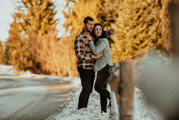 Beautiful couple explore the nature in the middle of snowy forest. Love story. Selective focus.