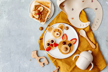 Animal Shaped Pancake with strawberry and fruit for kids. Plate with funny pancake. Funny breakfast idea for children. Kids meal. Flat Lay