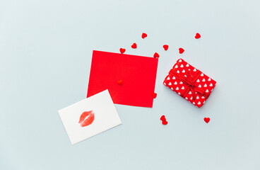 Flat lay of paper envelope with blank mockup greeting card. Grey table background with Valentine day gift, letter, heart shape and decoration. Top view, mock up invitations