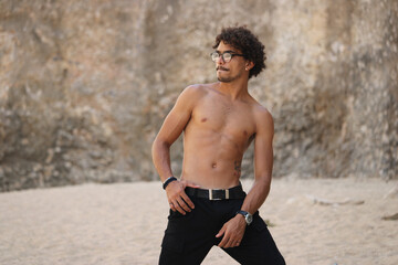 Latin young male wearing black pants and glasses
