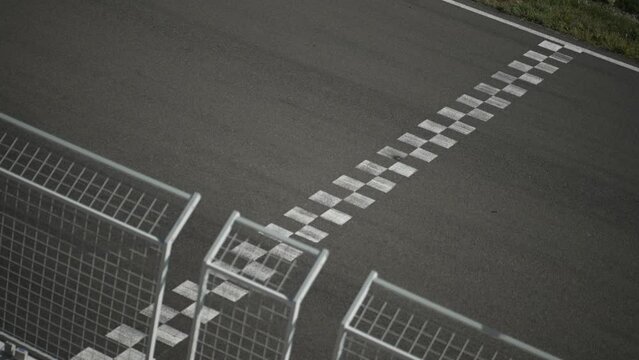 Finish Line with a couple of bikes passing in slow motion; 100 fps slowed to 25