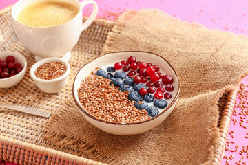 Tray with bowl of sweet yogurt with flax seeds, berries and cup of coffee on color background