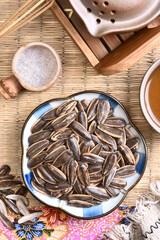 Sunflower seeds on a plate with hot tea  
