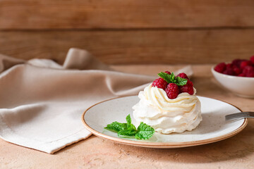 Plate of tasty Pavlova cake with fresh berries on table