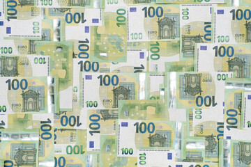 Banknotes Heap, cash money in nominal 100 Euro. currencies Wallpaper of European money Finance background. Top view