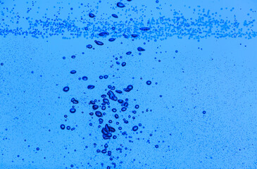 Clear water with air bubbles on blue background