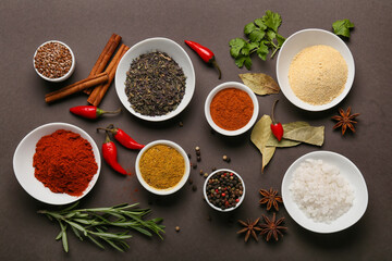 Composition with aromatic spices and herbs on dark background