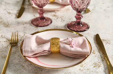 Stylish table setting on light grunge background