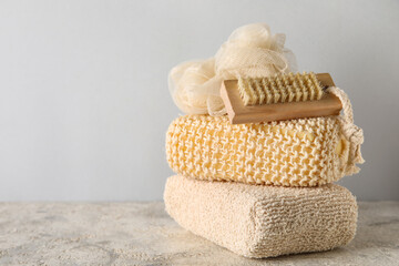 Fototapeta na wymiar Different bath sponges and massage brush on table