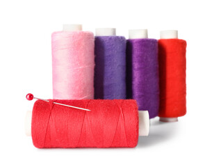 Different sewing threads with needle on white background