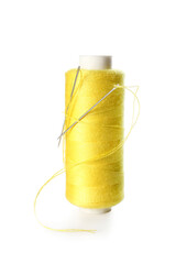 Yellow sewing thread spool on white background