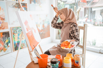 muslim female artist while working in her project at studio