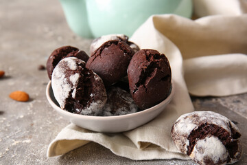 Bowl of chocolate brownie cookies on grey background