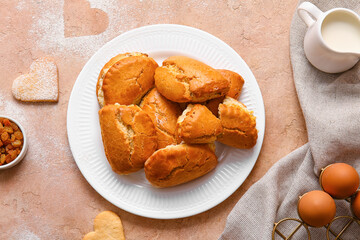 Plate of tasty sochniki with cottage cheese on beige background