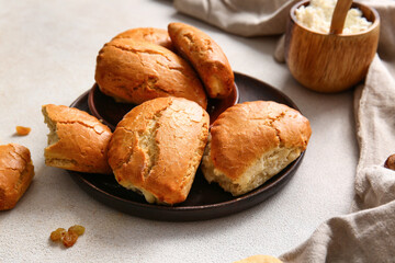 Plate of tasty sochniki with cottage cheese on light background