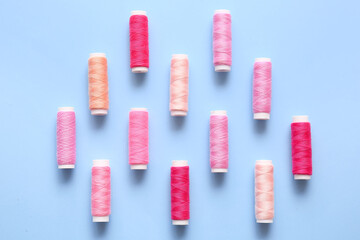 Thread spools on blue background