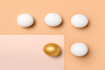 Golden Easter egg among white ones on color background
