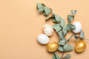 Fototapeta na wymiar Beautiful Easter eggs with eucalyptus branches on color background