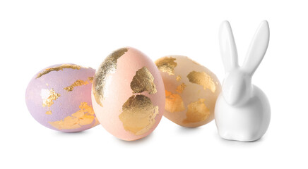 Easter eggs decorated with gold foil and bunny on white background