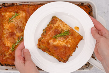 Spinach lasagna. Delicious spinach lasagna served with fresh rosemary close up on a plate