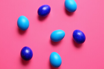 Blue painted Easter eggs on color background