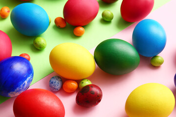 Different painted Easter eggs on color background