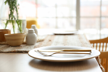 Table with setting served for International Women's Day celebration in kitchen, closeup