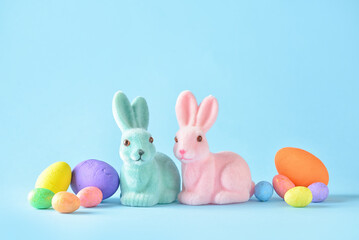 Cute Easter bunnies and eggs on blue background