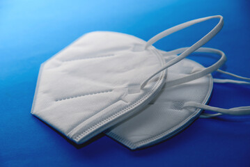 N95 medical mask for protection against virus and covid-19 on a blue background