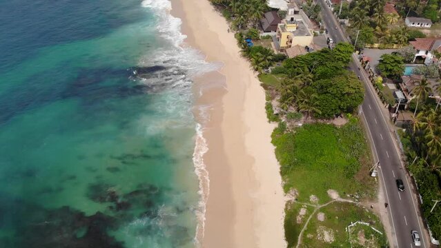 Vertical aerial view of Indian ocean waves and coast in Sri Lanka