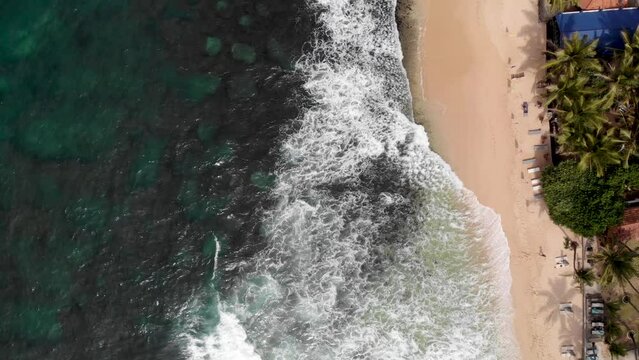 Vertical aerial view of Indian ocean waves and coast in Sri Lanka