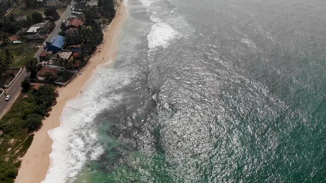 Vertical aerial view of Indian ocean waves and coast in Sri Lanka