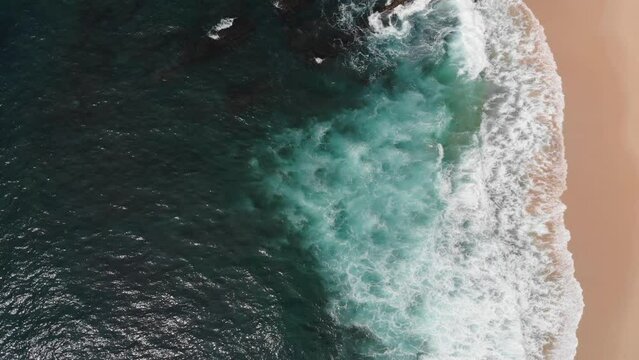 Vertical aerial view of Indian ocean waves and coast in Sri Lanka