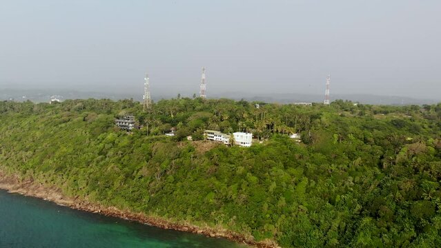 Aerial view of an ocean bay, mountains and antenna towers in Sri Lanka
