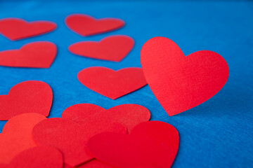 Paper cut red hearts shape on blue textured background with copy space. Concept image. Valentine's day, mother's day, birthday greeting cards, invitation, celebration