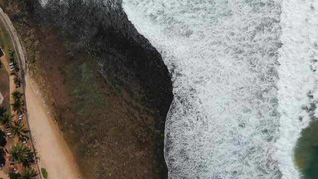 Vertical aerial view of Indian ocean waves and coast in Sri Lanka