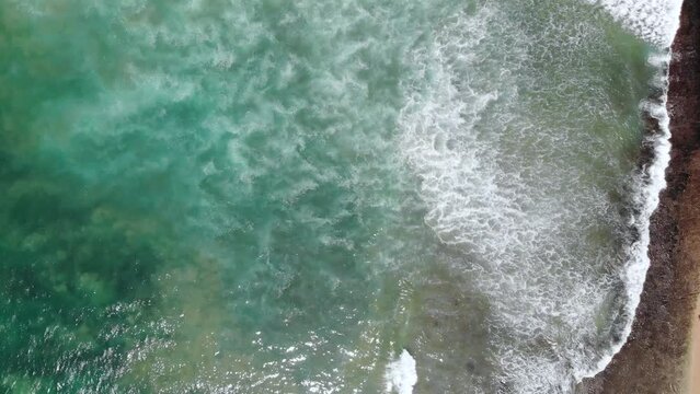 Vertical aerial view of Indian ocean waves and coast in Sri Lanka
