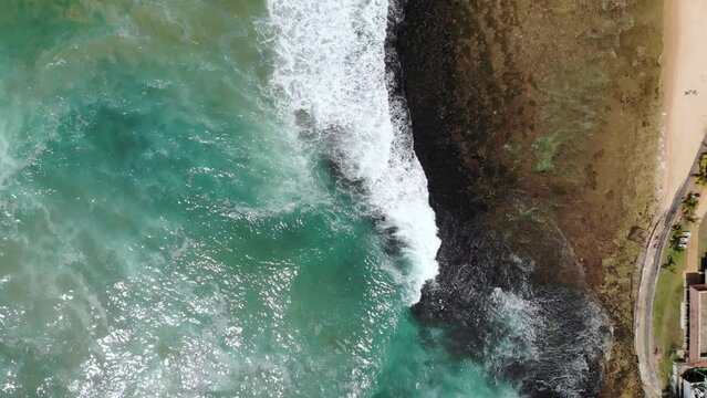 Vertical aerial view of Indian ocean waves and coast in Sri Lanka