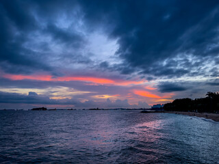 Sunset over the sea with dark clouds