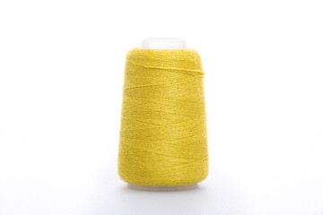 Yellow spool of thread isolated on white background. Skein of woolen threads. Yarn for knitting. Materials for sewing machine. Coil.