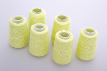 Yellow spool of thread isolated on white background. Skein of woolen threads. Yarn for knitting....