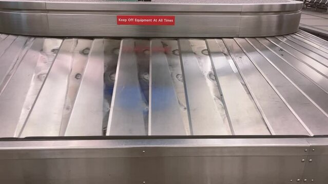 Close up shot of empty baggage claim conveyer belt in motion
