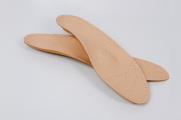 Isolated orthopedic insoles on a white background. Medical insoles. Foot care. Insole cutaway...