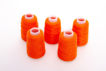 Red spool of thread isolated on white background. Skein of woolen threads. Yarn for knitting....
